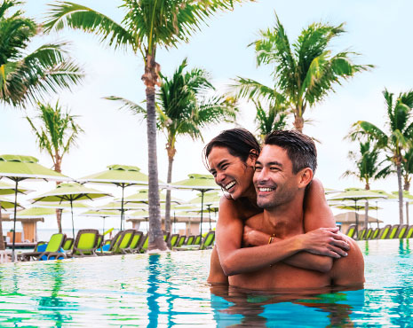 Couple in a tropical infinity pool