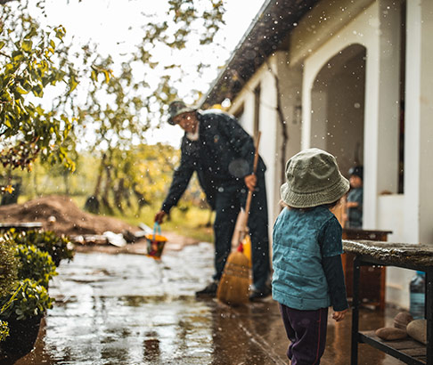 man-child-cleaning-up-after storm-486x410