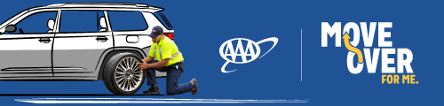AAA Roadside Assistance helping change tire on side of road