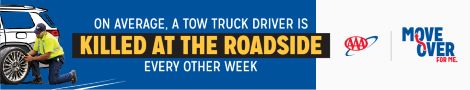 Roadside Assistance changing tire on car. On average, a tow truck driver is killed at the roadside every other week. 