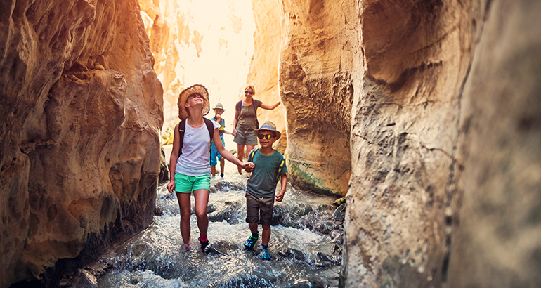 AAA members with travel insurance walking confidently in their vacation destination
