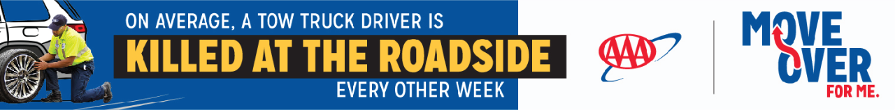 Roadside Assistance changing tire on car. On average, a tow truck driver is killed at the roadside every other week. 