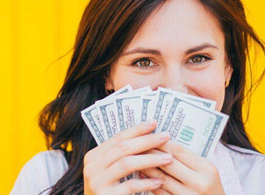 Woman with cash in her hand - Impressive Returns on Savings and Checking Accounts