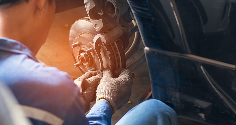 Mechanic replacing brakes