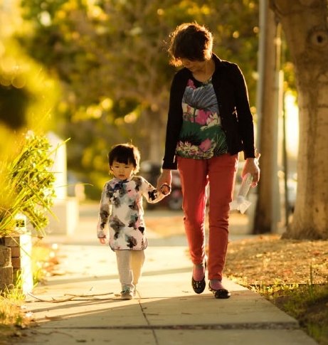 Grandmother with AAA condo insurance walks with her granddaughter 