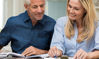 Couple discussing home and auto insurance policy coverage options