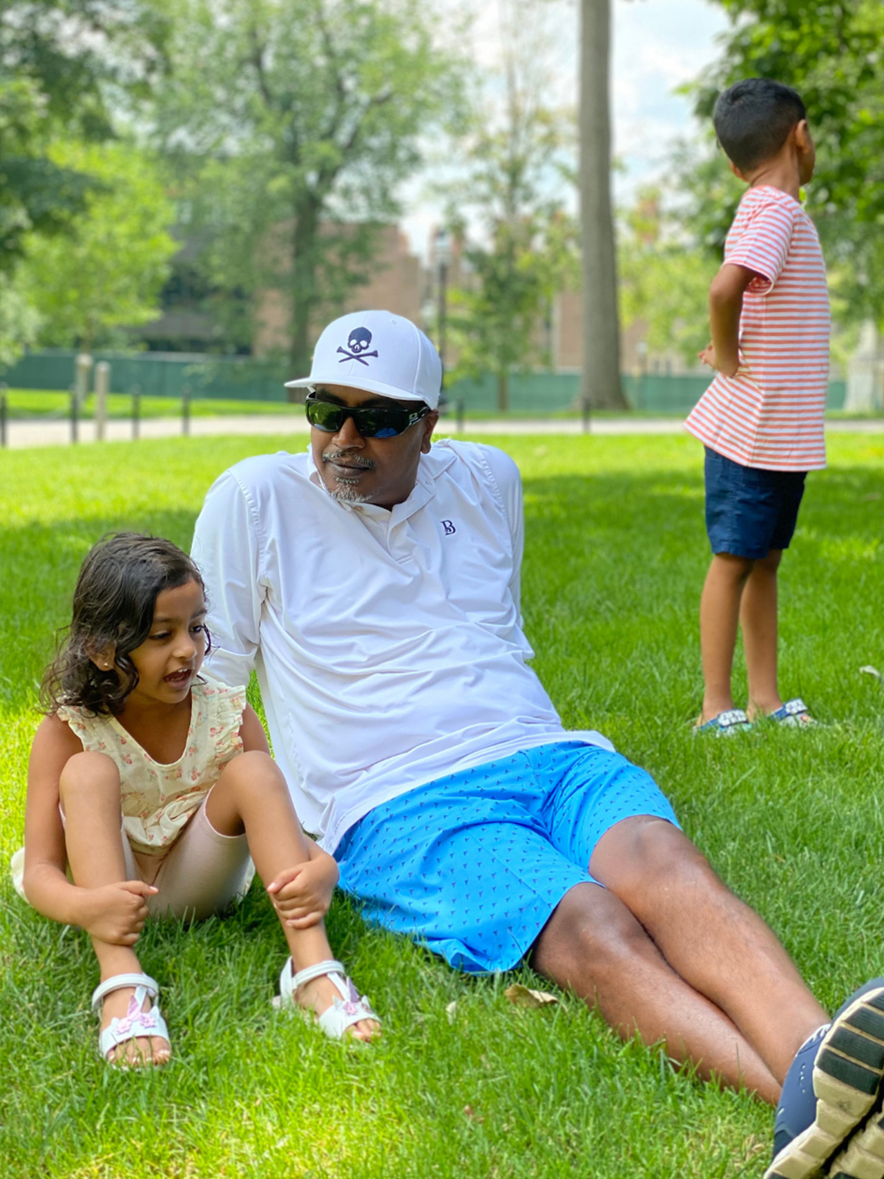 Dad and two kids in a park enjoying the warm weather