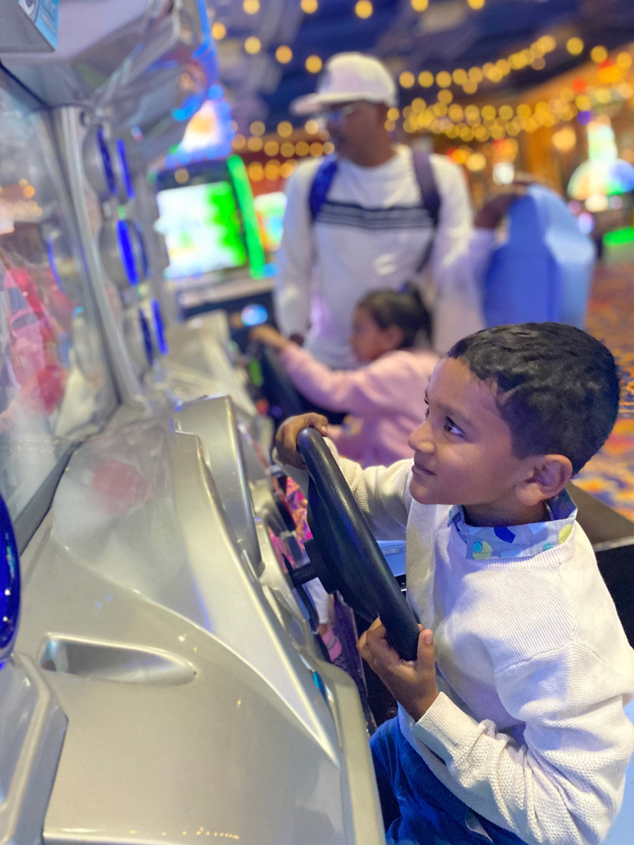Kids with Dad in a game arcade having fun
