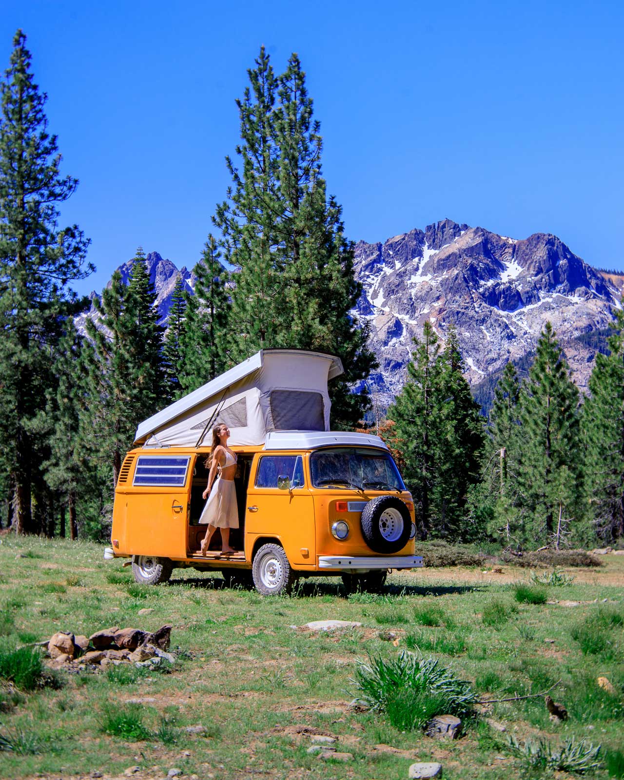 Woman in back of van drinking coffee