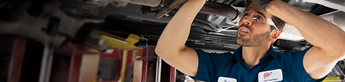 Female mechanic and customer looking under hood of car in AAR shop