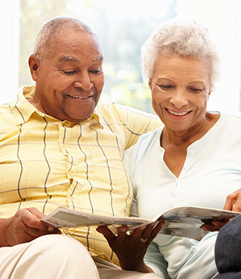 Couple reading free AAA Living magazine, a free AAA benefit