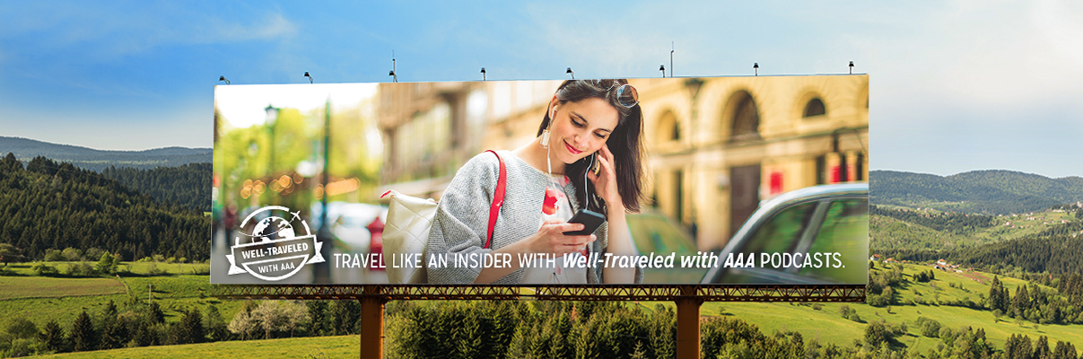 USA Road Trips with AAA Podcasts and billboard with rolling hills behind it