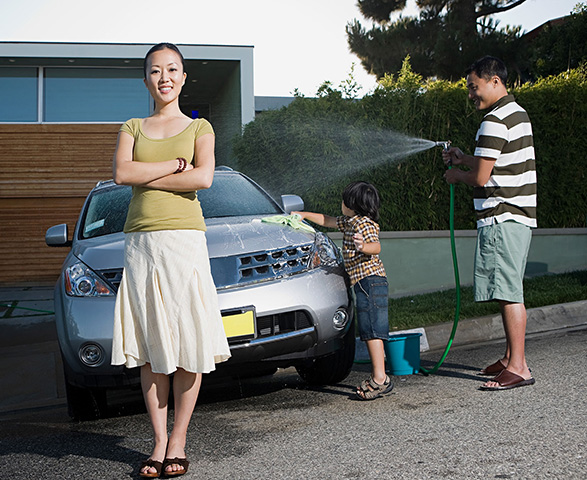Family with home and condo insurance washing the car