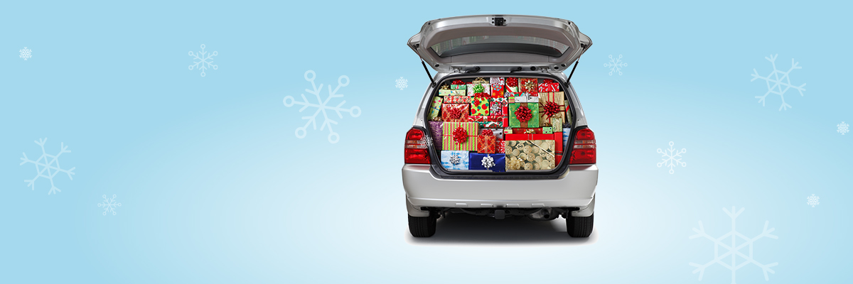 car with a trunk full of presents on a blue snowflake background