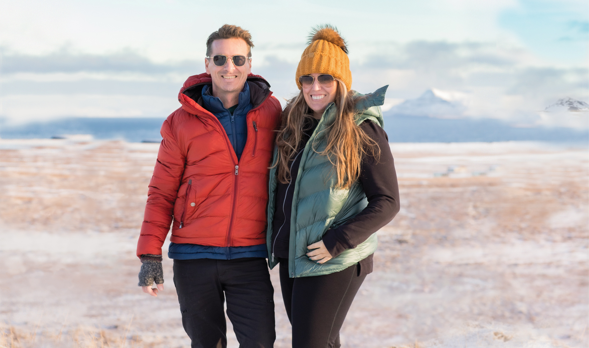 Man and woman standing in Iceland with winter clothing 