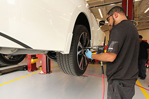 Mechanic testing tire pressure