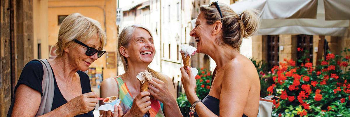 3 mature ladies eating gelato in Italy
