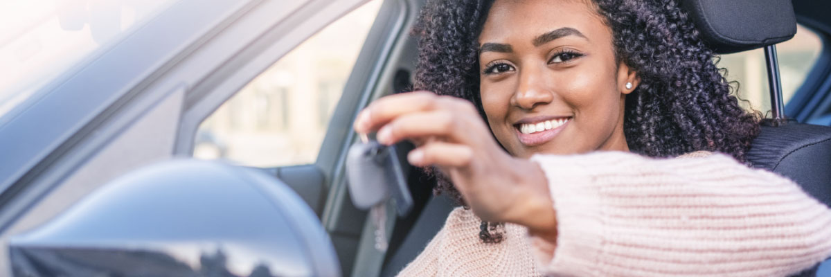 women in car with keys